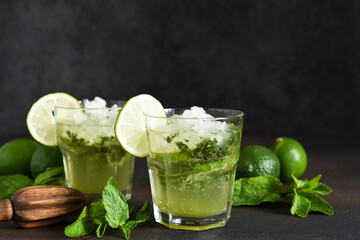 Summer cocktail. Classic summer drink - mojito in a glass on a dark background.