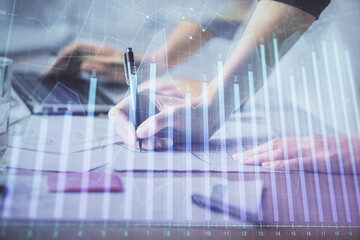 Multi exposure of woman hands typing on computer and financial chart hologram drawing. Stock market analysis concept.