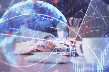 Double exposure of woman hands typing on computer and forex chart hologram drawing. Stock market invest concept.
