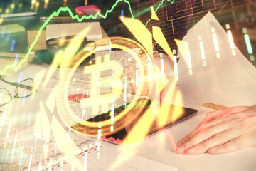 Fototapeta premium Double exposure of man's hands holding and using a phone and crypto currency blockchain theme drawing.