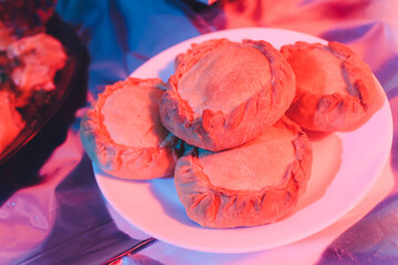 Traditional russian chicken pie kurnik on a plate laying on a table napkin, top view, horizontal. © Евгений Вершинин