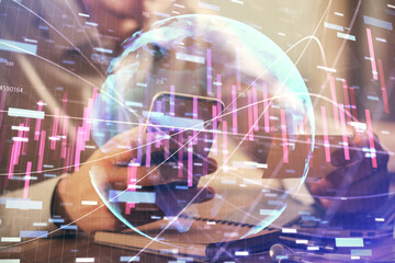 Double exposure of man's hands holding and using a phone and financial graph drawing. Analysis concept.