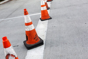 Safety cones along a traffic cross walk. Urban street scene.