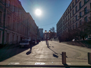 Low Sun over Stoleshnikov lane in the direction of Moscow city Hall against a cloudless sky
