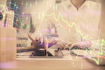 Double exposure of forex chart sketch hologram and woman holding and using a mobile device. Financial market concept.