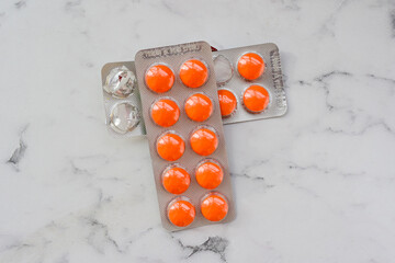 Pharmaceuticals, vitamins large and round orange in the package is on the table
