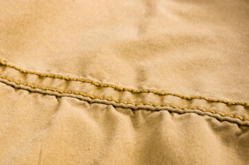 clothing items stonewashed cotton fabric texture with seams, clasps, buttons and rivets, macro