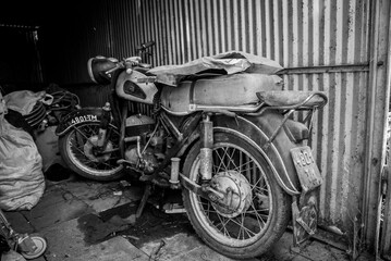 Old school Polish motorcycle in garage. Vintage black and white picture of famous 20th century motorbike.