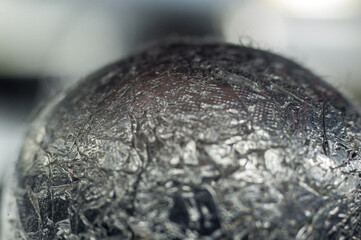 Unusual abstract techno view of crumpled aluminum foil ball, close-up, macro photography