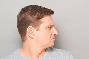Obraz premium Portrait of angry disgruntled mature man with frowning face