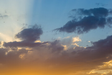 Landscape with dramatic light - beautiful golden sunset with saturated sky and clouds.