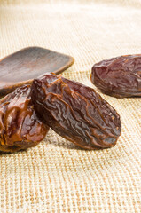 Big luxury dried date fruit on a linen napkin, kurma ramadan kareem concept, close up.