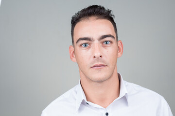 Portrait of young handsome businessman against white background