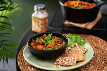 Spanish Pardina Lentil and Chorizo Stew with vegetables on a table. Selective focus, copy space. Mediterranean cuisine.