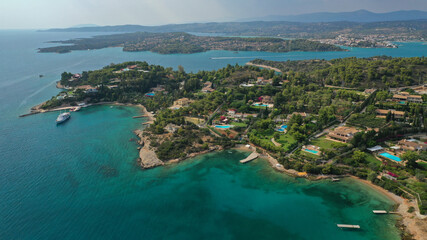 Fototapeta na wymiar Aerial drone photo of beautiful fjord landscape forming turquoise beaches in small vegetated coves in Porto Heli a popular anchorage for yachts and sail boats, Argolida, Greece