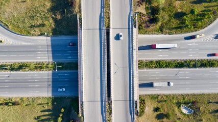 Aerial view of double lane highway, vehicle overpass and side road