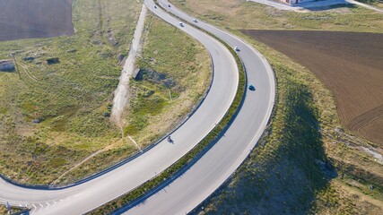 Aerial view of double lane highway, vehicle overpass and side road