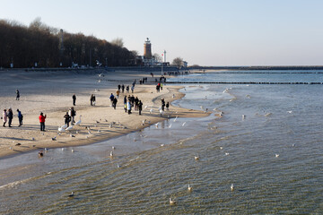 People winter walking at Baltic Sea in Kolobrzeg