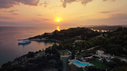 Aerial drone panoramic photo of famous fjord seaside village and bay of Porto Heli in the heart of Argolida prefecture at sunset, Peloponnese, Greece