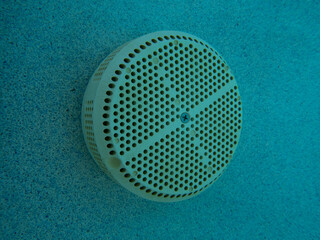 A pool suction equalizer in daylight