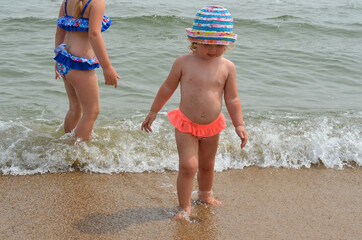 Two caucasian children outdoor in summer lifestyle on the beach