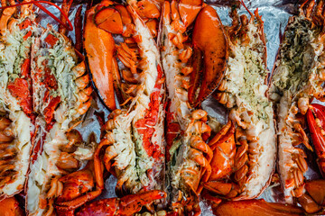 Boiled and baked lobsters in the cooking tray 
