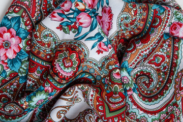 horizontal view closeup on crumpled white cotton scarf with paisley floral ornament