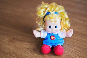Little colorful doll on a wooden table