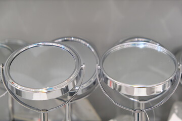 Several round mirrors in steel frames on a leg