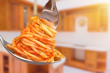 Metal fork with delicious spaghetti and sauce