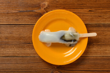 top view popsicle in a melting process with black sesame inside
