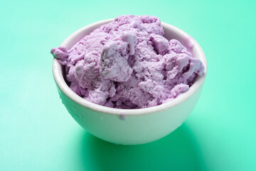 side view bowl of sweet potato flavor ice cream on a light green background
