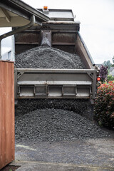 Dump Truck Unloading Crushed Rock at Home Driveway for Gravel Delivery