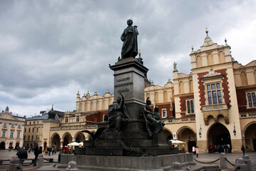 Fototapeta na wymiar Polish Pole people and foreign travelers travel visit Adam Mickiewicz Monument and shopping in Cloth Hall Sukiennice Krakow Old Town Main Square at Stare Miasto on September 20, 2019 in Lesser, Poland