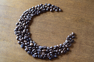 Coffee beans on a wooden table. roasted coffee beans on a wooden background.