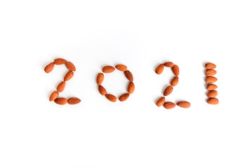 2021 number created from Almonds  on white background, New Year Concept