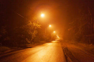 night desert two-lane road in the fog, along the road shine lanterns
