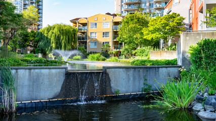 Cityscape of a modern residential area with apartment buildings, new green and watery urban...