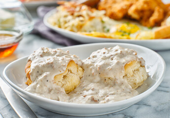 biscuits and gravy with sausage on plate