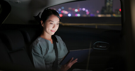 Woman work on tablet computer on car