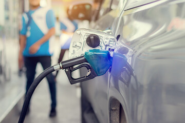 Close up of fuel monitoring system refueling a petroleum to vehicle at gas station.