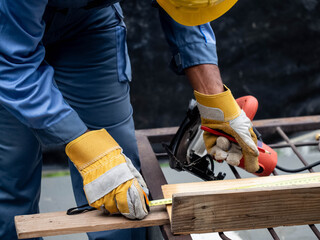 Technicians engineering skill carpentry uses tape measure meters wearing blue protective clothing are cutting off industrial factory steel electric wheels pipe 