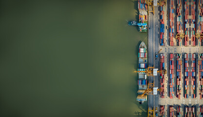 Aerial top view container cargo ship in import export business commercial trade Logistics and transportation of Container Cargo ship and Cargo plane with working crane bridge in shipyard at sunset