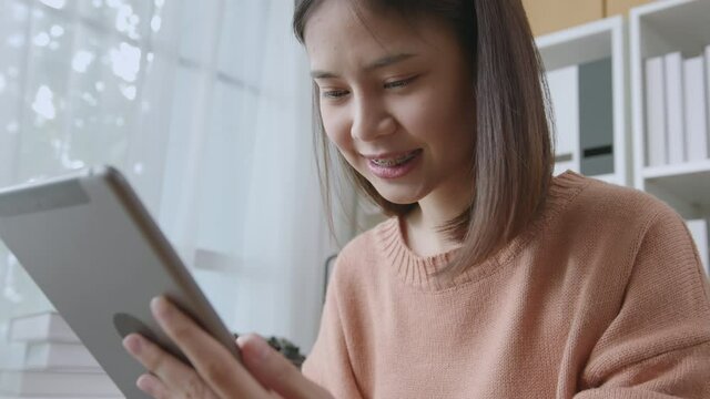 handle shot of woman holding digital tablet and using online social on lifestyle.