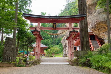 Torii at Takkoku-no-Iwaya Bisyamondo Hall in Hiraizumi, Iwate, Japan. The temple was founded by Sakanoue no Tamuramaro in 801 AD.