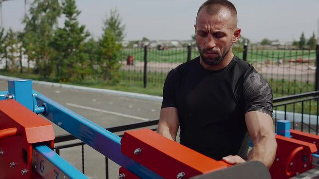 The man adjusts the exerciser load system. Weight picking. The concept of a healthy lifestyle