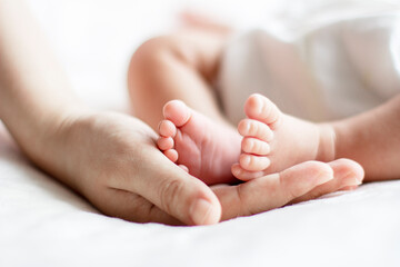 Baby and mother holding footers, cropped, close-up