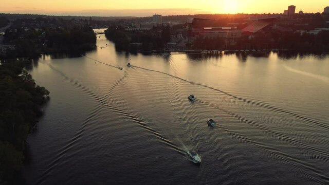 Aerial View of Boats Traveling by University of Washington Stadium in Golden Hour Lighting