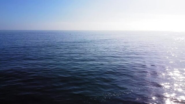 Beach. Newport Coast, California. Slow glide above the still ocean. 18 sec.