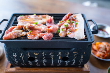 grilled slice poek with charcoal stove